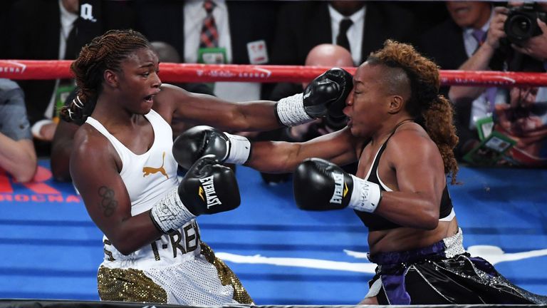 Claressa Shields (L) hits Franchon Crews with a left in the second round of their super middleweight bout at T-Mobile Arena