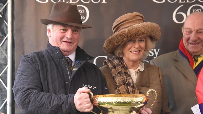 Camilla, Duchess of Cornwall presents the trophy to winning trainer Colin Tizzard after Native River took the 60th Hennessy Gold Cup.