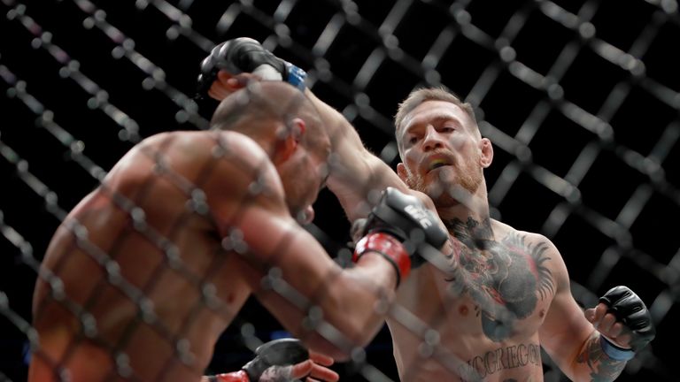 NEW YORK, NY - NOVEMBER 12:  (R-L) Conor McGregor of Ireland punches Eddie Alvarez in their UFC lightweight championship fight in their UFC lightweight cha