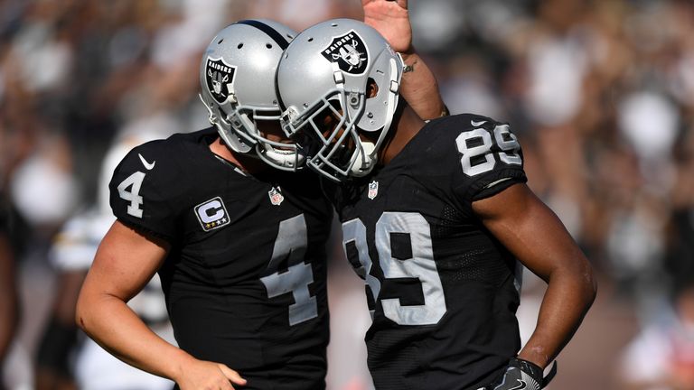 OAKLAND, CA - OCTOBER 09:  Derek Carr #4 of the Oakland Raiders celebrates with Amari Cooper #89 after a scoring on a two-point conversion against the San 