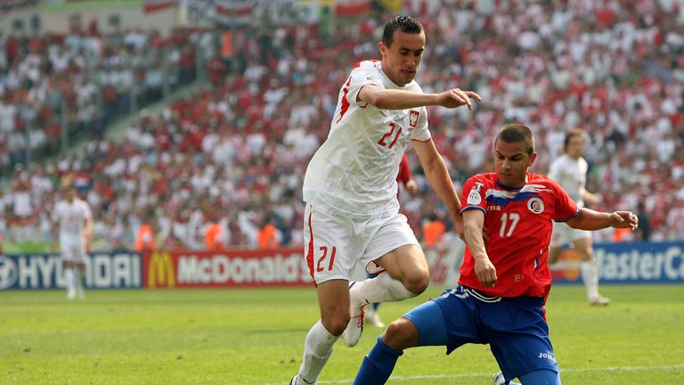 HANOVER, GERMANY - JUNE 20: Irenuesz Jelen of Poland is tackled by Gabriel Badilla of Costa Rica during the FIFA World Cup Germany 2006 match between Costa