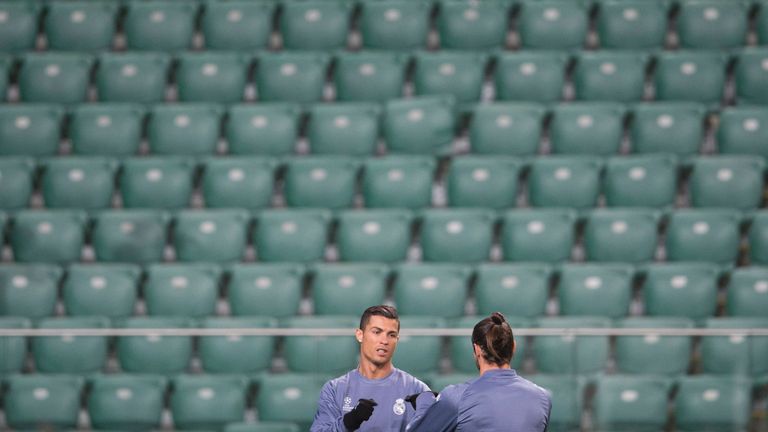 Real Madrid's Cristiano Ronaldo and Gareth Bale warm up in Legia Warsaw's empty stadium 