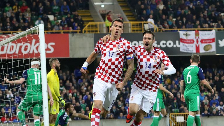 Croatia's midfielder Mario Mandzukic celebrates scoring his team's first goal with Croatia's forward Duje Cop during the friendly international football