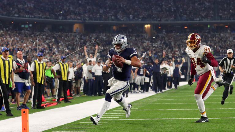 ARLINGTON, TX - NOVEMBER 24:   Dak Prescott #4 of the Dallas Cowboys rushes for a touchdown during the fourth quarter against the Washington Redskins at AT