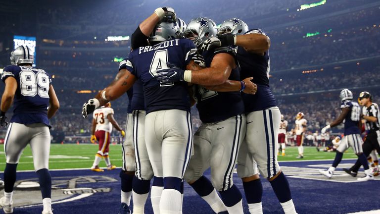 ARLINGTON, TX - NOVEMBER 24:   Dak Prescott #4 of the Dallas Cowboys celebrates with teammates after scoring a touchdown during the fourth quarter against 