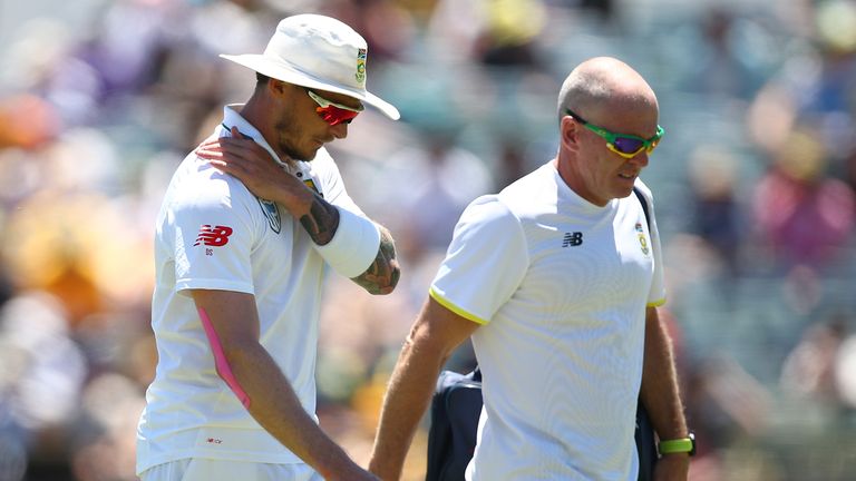 PERTH, AUSTRALIA - NOVEMBER 04:  Dale Steyn of South Africa walks from the field with the team physio after injuring his shoulder during day two of the Fir