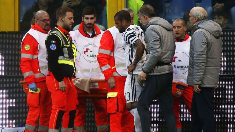 Juventus' Brazilian defender Daniel Alves (C) leaves the pitch after being injured during the Italian Serie A football match Genoa vs Juventus on November 