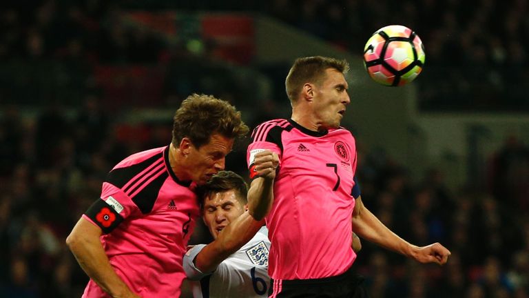 Scotland's midfielder Darren Fletcher (R) heads the ball past England's defender John Stones (C) during a World Cup 2018 qualification match between Englan