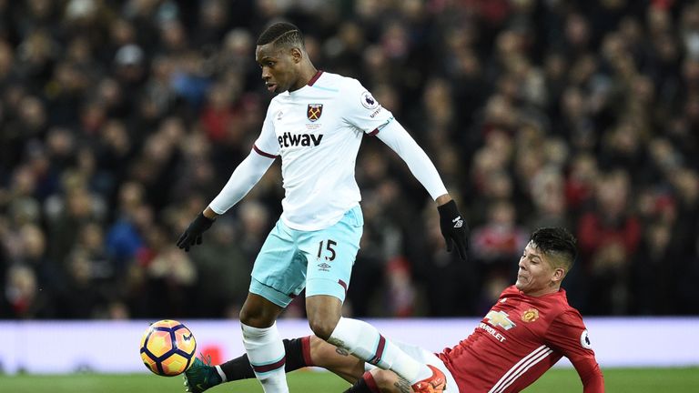 Manchester United's Argentinian defender Marcos Rojo (R) tackles West Ham United's Senegalese striker Diafra Sakho (L) during the English Premier League fo