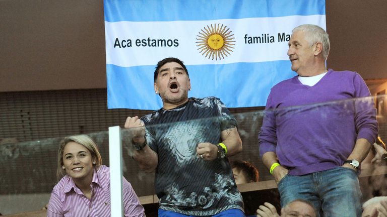 Argentinian retired professional footballer Diego Armando Maradona (C) and his girlfriend Rocio Olive react during  the Davis Cup World Group final singles