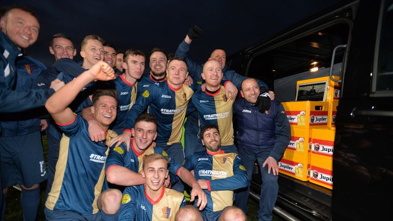 EAST KILBRIDE, SCOTLAND - NOVEMBER 05: The East Kilbride players and staff celebrate with beer presented by Ajax club officials after winning there 27th ga