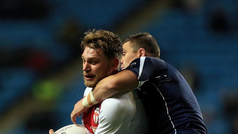 Elliott Whitehead of England is tackled by Danny Brough of Scotland during the Four Nations match at Coventry