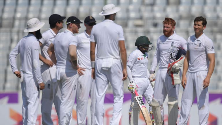 Bangladesh's captain Mushfiqur Rahim (3rd R) looks on as England's cricketers wait for a review decision during the third day of the second Test