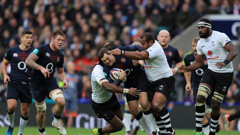 Alex Goode of England is tackled by Albert Vulivuli and Sunia Koto of Fiji 