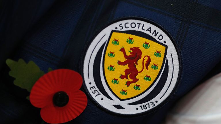 A Scottish supporter wears a Scotland jacket with a red poppy to pay respect to the country's war dead before a World Cup 2018 qualification match between 