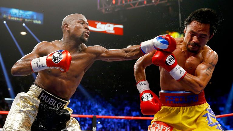  Floyd Mayweather Jr. throws a left at Manny Pacquiao during their welterweight unification championship bout on May 2, 2015 at MGM