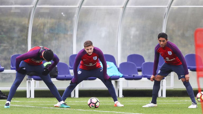 Jordan Henderson, Adam Lallana and Tottenham youth player Dylan Duncan warm up during and England training session