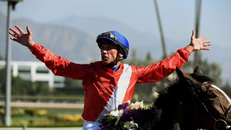 Jockey Frankie Dettori celebrates after riding Queen's Trust to win the Breeders' Cup Filly and Mare Turf.