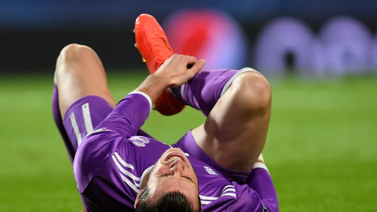 Real Madrid's Welsh forward Gareth Bale grimaces as he lies on the pitch during the UEFA Champions League football match Sporting CP vs Real Madrid CF at t