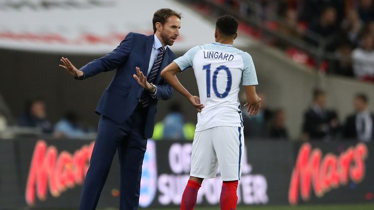 England caretaker manager Gareth Southgate (left) gives instructions to England's Jesse Lingard 
