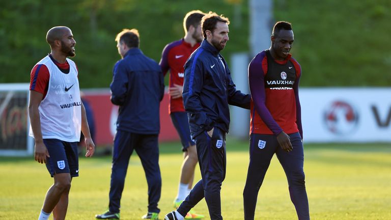 BURTON-UPON-TRENT, ENGLAND - OCTOBER 04:  Interim England manager Gareth Southgate speaks with Michail Antonio during an England training session at St Geo