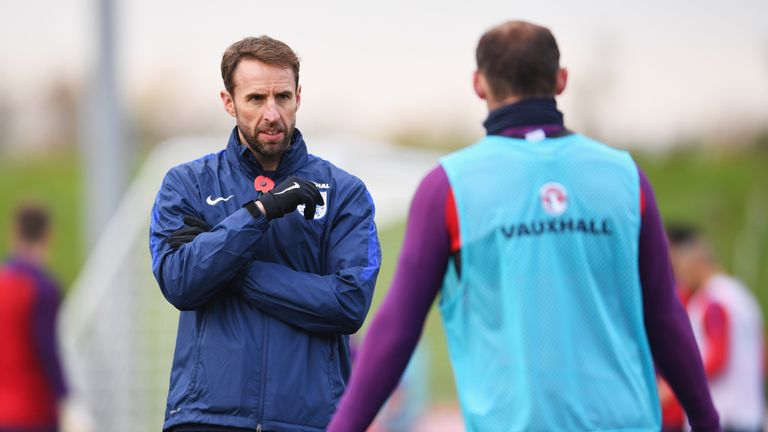 Gareth Southgate in discussion with Wayne Rooney during an England training session