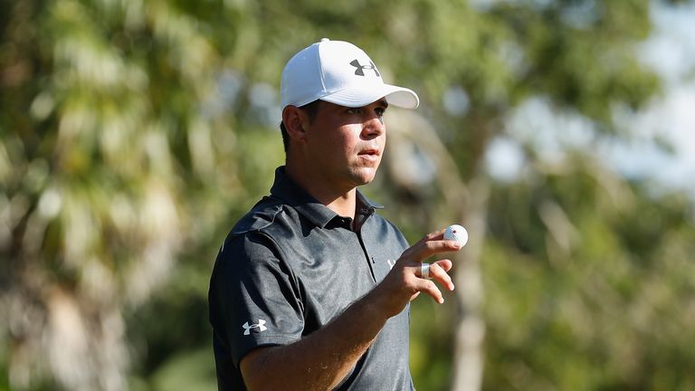 Gary Woodland waves to fans after making a par on the 18th green