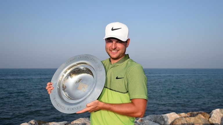 Jordan Smith of England poses with the Road to Oman rankings trophy