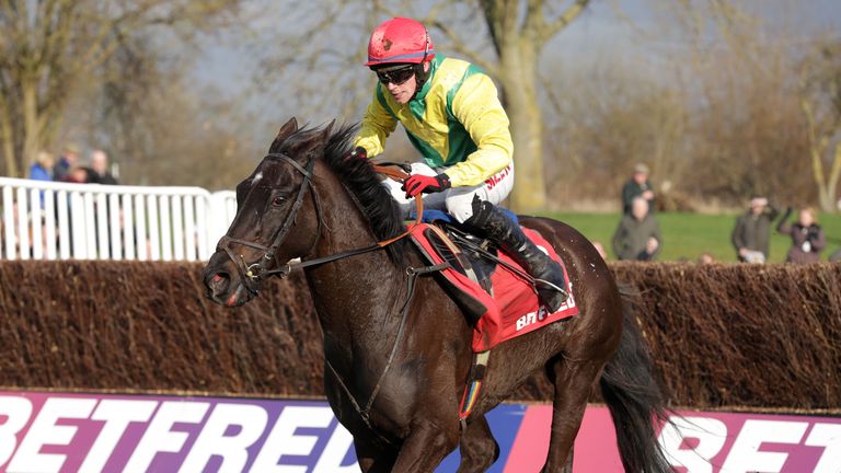 UTTOXETER, ENGLAND - MARCH 14:  Jonathan Burke riding Goonyella races up the home straight after clearing the last hurdle to win the Betfred Midlands Grand