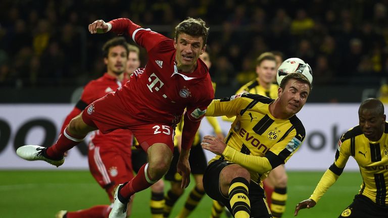 Bayern Munich's midfielder Thomas Mueller and Dortmund's midfielder Mario Goetze vie for the ball during the German first division Bundesliga football matc