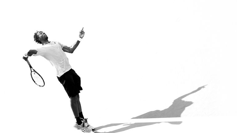 Gael Monfils of France serves to Grigor Dimitrov of Bulgaria during the US Open in 2014