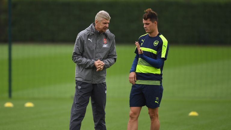 ST ALBANS, ENGLAND - SEPTEMBER 27:  Manager Arsene Wenger of Arsenal talks to Granit Xhaka during an Arsenal training session ahead of the Champions League