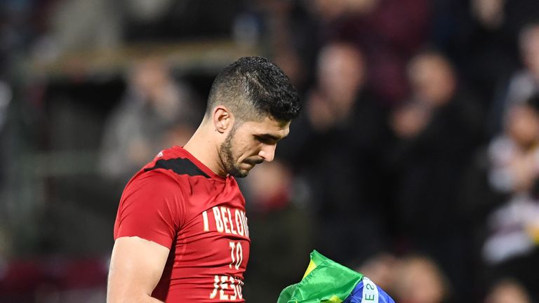 Hearts' Igor Rossi holds the Brazilian flag at the end of the game 