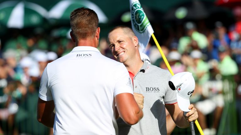 Alex Noren is congratulated by Race to Dubai leader and fellow Swede Henrik Stenson on the 18th green