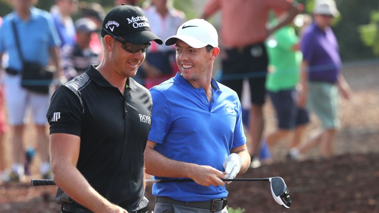 DUBAI, UNITED ARAB EMIRATES - NOVEMBER 20:  Rory McIlroy of Northern Ireland and Henrik Stenson of Sweden walk down the 1st hole during day four of the DP 