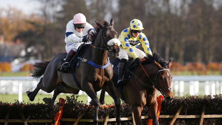 ASCOT, ENGLAND - NOVEMBER 18: Richard Johnson riding Kimberlite Candy (L) clear the last to win The Geotech Soil Stablisation 'Nation Hunt' Maiden Hurdle R