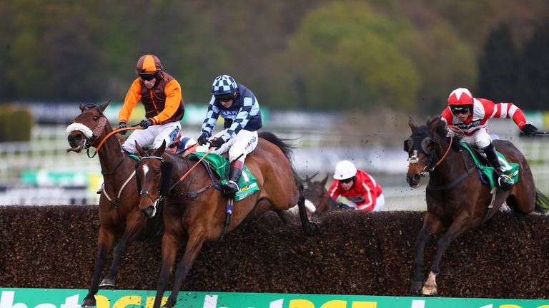 Sam Waley-Cohen (L, brown and orange) rides The Young Master to win the bet365 Gold Cup 