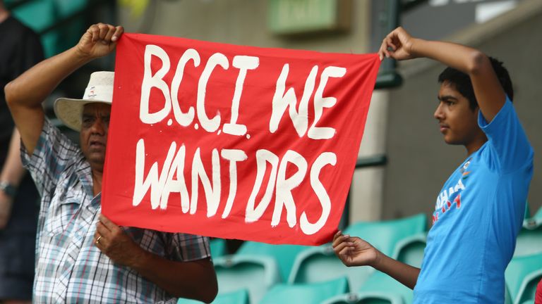 Indian supporters in the crowd hold up a sign about the DRS during day one of the Fourth Test match against Australia