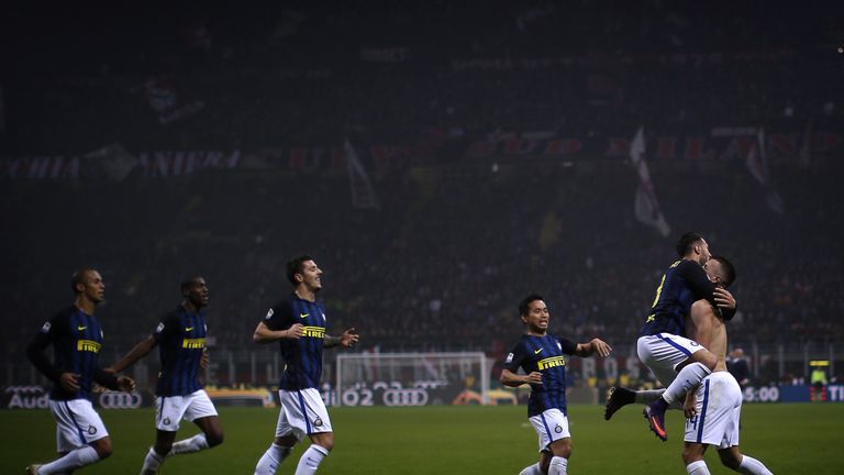 Inter Milan's forward Ivan Perisic from Croatia (R) celebrates with teammates after scoring during the Italian Serie A football match AC Milan Vs Inter Mil