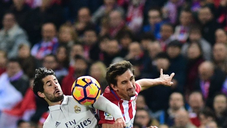 Isco (L) vies with Stefan Savic during the Spanish league football match between Atletico Madrid and Real Madrid