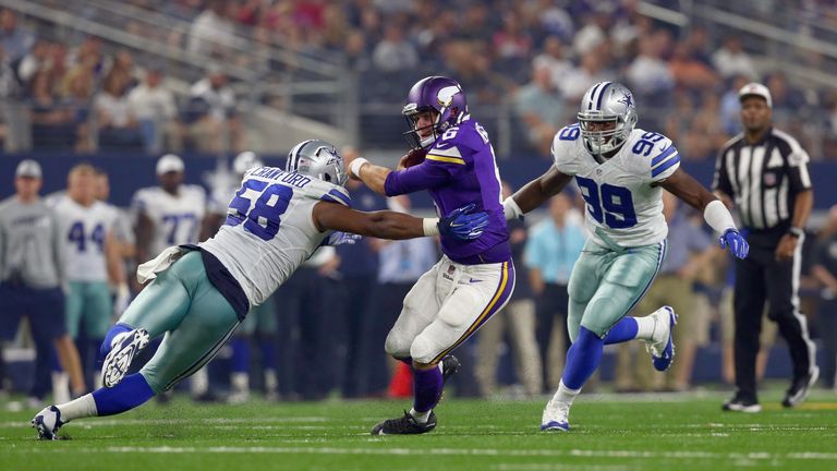 ARLINGTON, TX - AUGUST 29:   Taylor Heinicke #6 of the Minnesota Vikings carries the ball against  Jack Crawford #58 of the Dallas Cowboys and  Ryan Russel