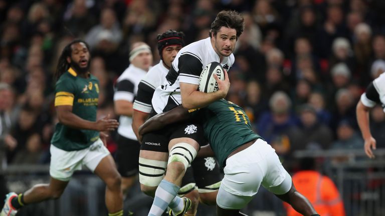 LONDON, ENGLAND - NOVEMBER 05:  Sam Carter of Barbarians is tackled by Jamba Ulengo of South Africa during the Killik Cup match between Barbarians and Sout