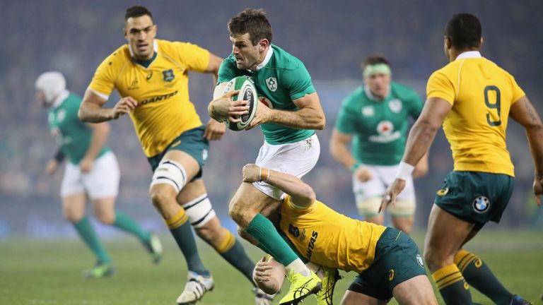 Ireland's centre Jared Payne (C) is tackled