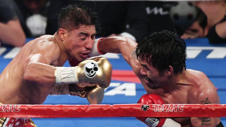 Manny Pacquiao (R) hits Jessie Vargas during their WBO welterweight title bout in Las Vegas