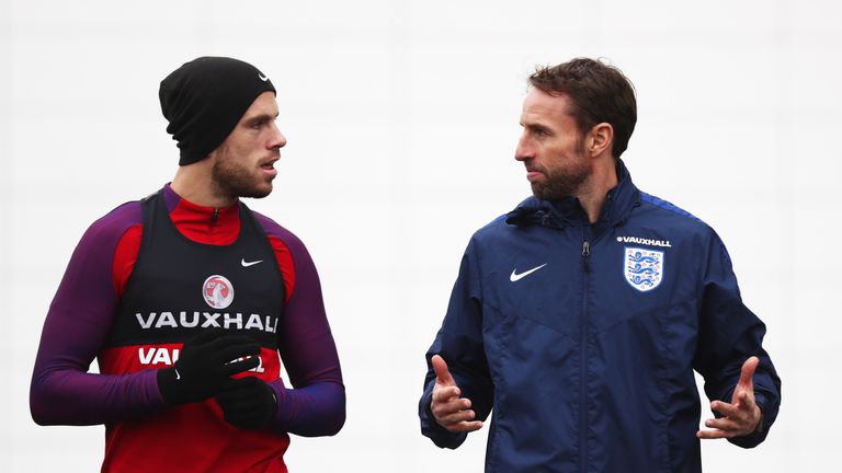 Jordan Henderson talks with Gareth Southgate during an England training session