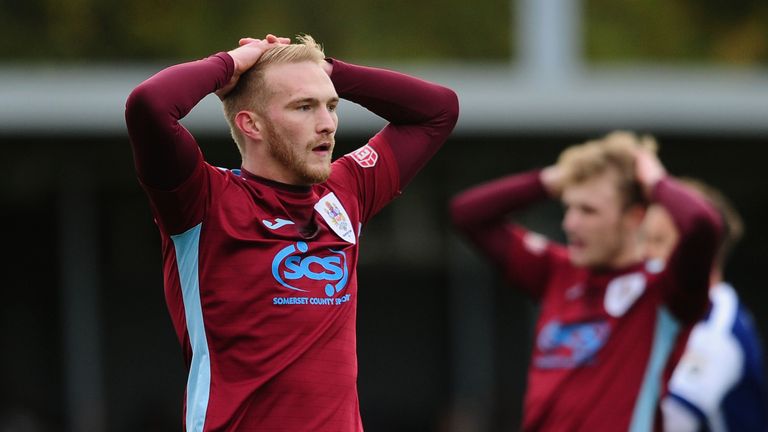 Jordan Rogers of Taunton Town (L) cuts a dejected figure during the FA Cup First Round match against Barrow