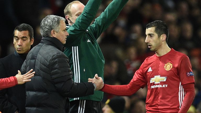 Manchester United's Armenian midfielder Henrikh Mkhitaryan (R) shakes hands with Manchester United's Portuguese manager Jose Mourinho (L) as he is substitu