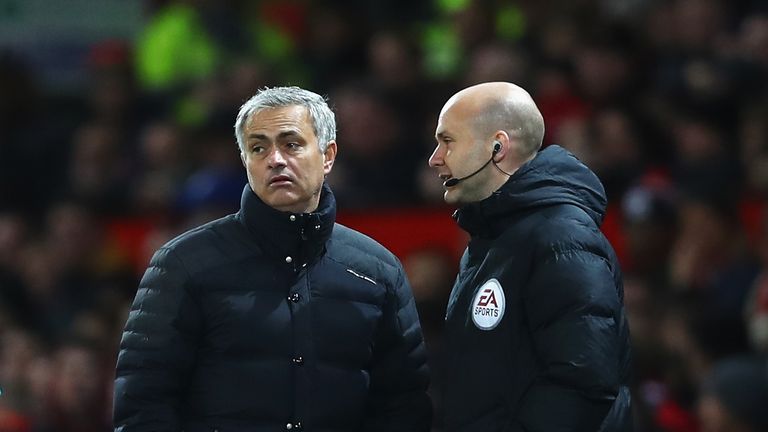 MANCHESTER, ENGLAND - NOVEMBER 27:  Jose Mourinho, Manager of Manchester United (L) speaks to Anthony Taylor, the fourth offical during the Premier League 