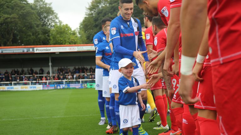 Joshua McCormack shakes hands as Rochdale's mascot early in the 2016-17 season