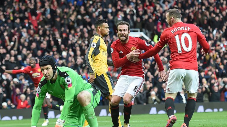 Manchester United's Spanish midfielder Juan Mata (R) celebrates scoring his team's first goal with Manchester United's English striker Wayne Rooney during 